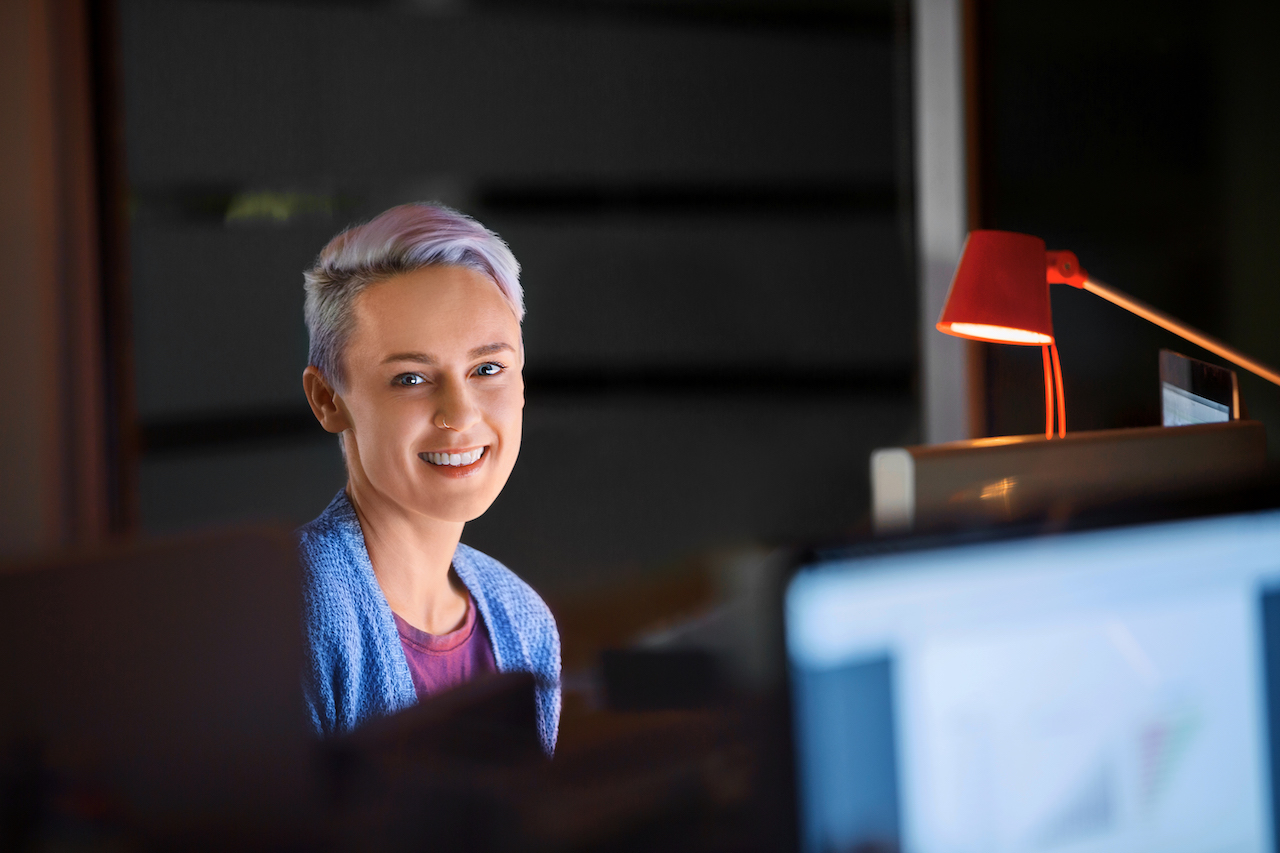 Happy software developer using an AI code assistant
