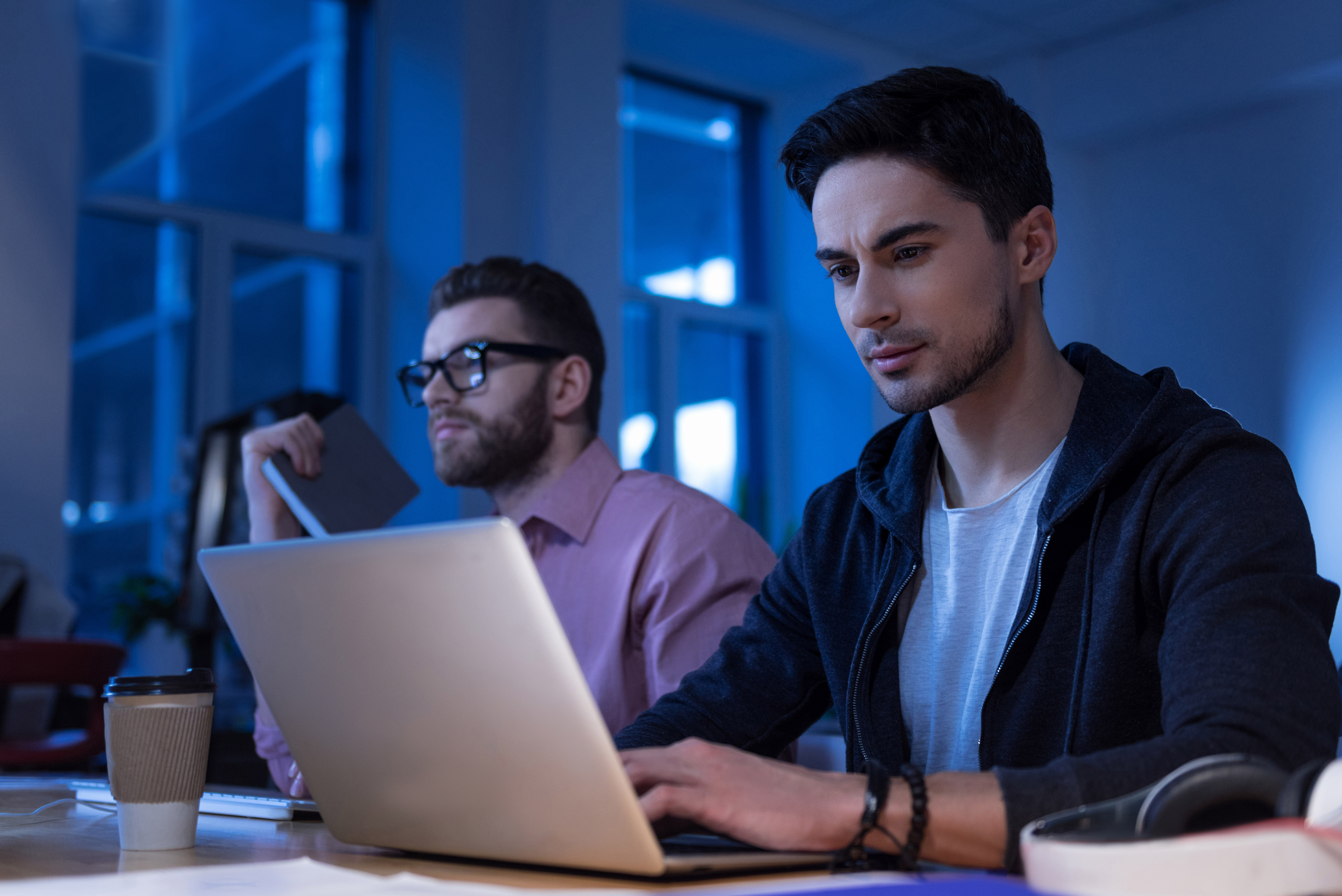 Man working on laptop in office setting