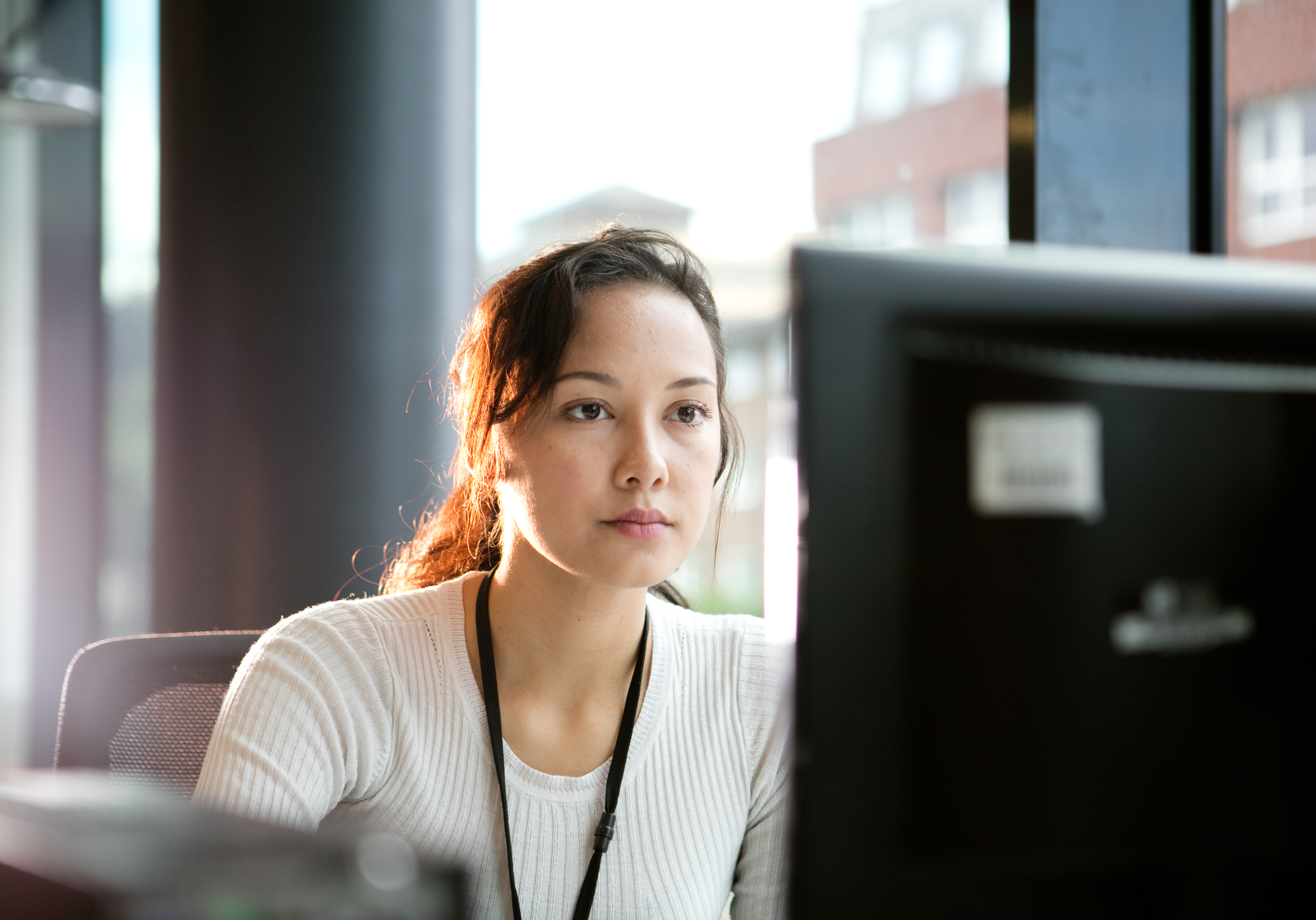 Woman looking at computer screen in office setting