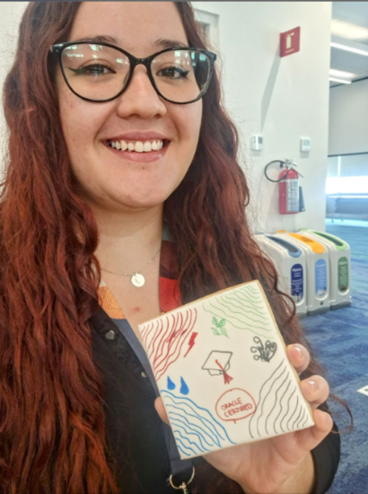 Claudina Guerra holding a painting project from team building event