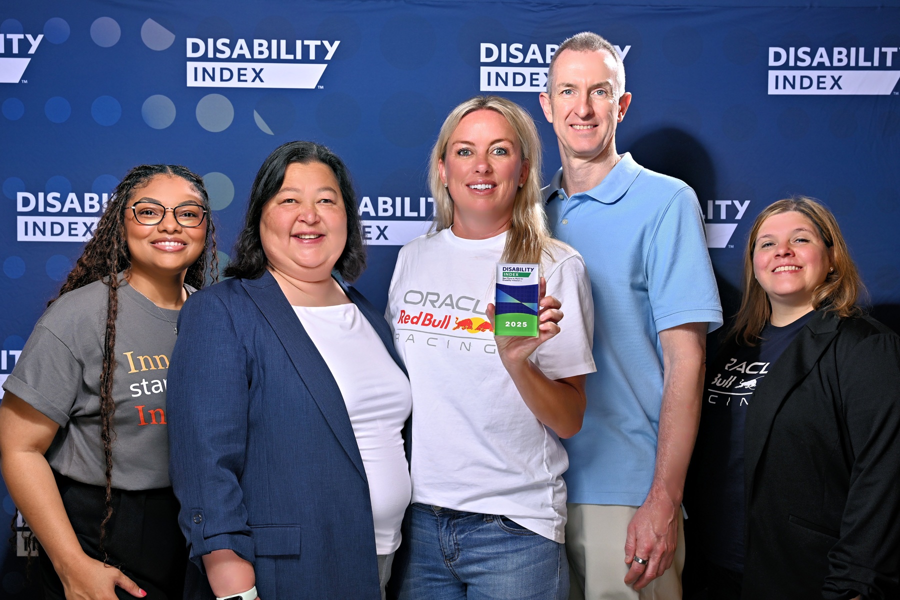 Oracle team accepting the top score on Disability: IN Index against photo backdrop