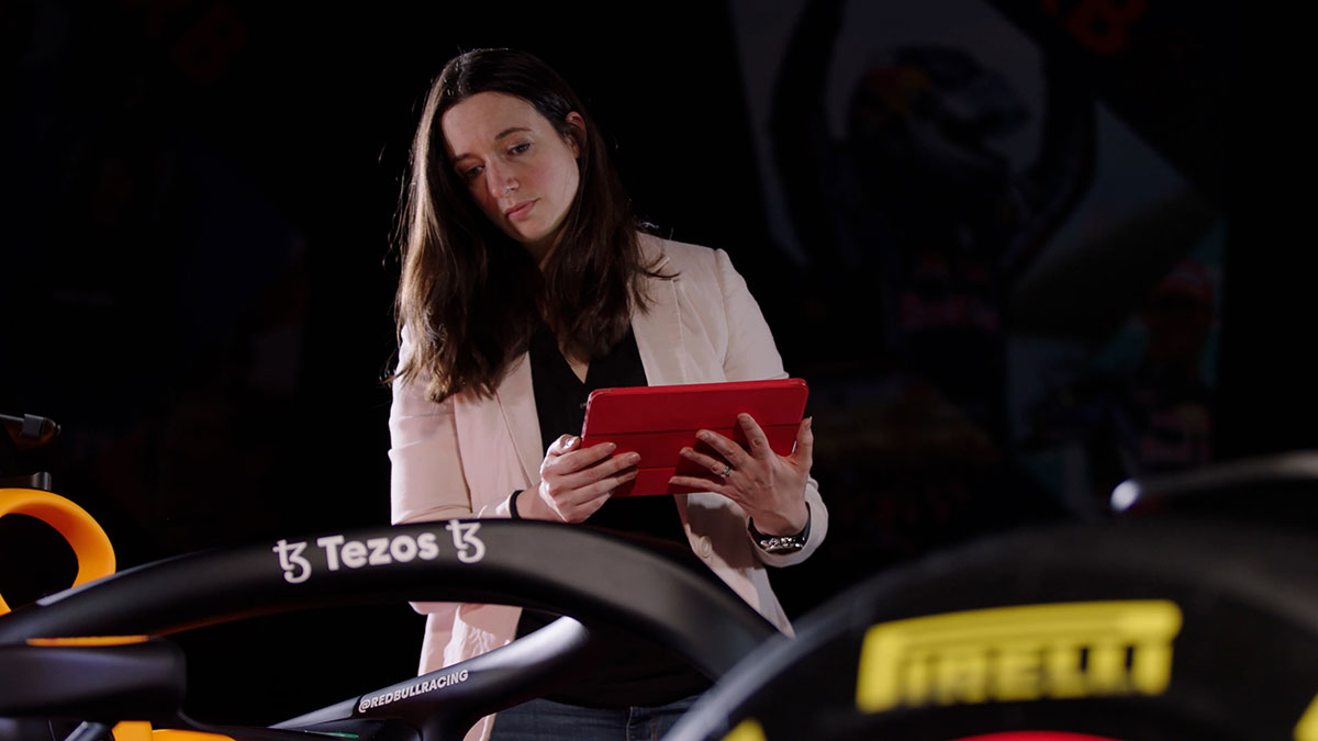 Oracle Red Bull Racing race strategist standing next to one of the team's vehicles