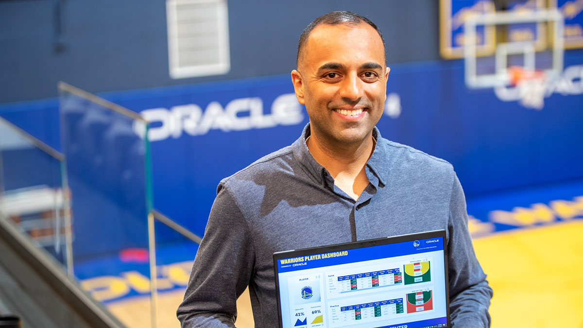 Pabail Sidhu, Director of Basketball Analytics and Innovation, Golden State Warriors holding a laptop computer with the team's player dashboard displayed