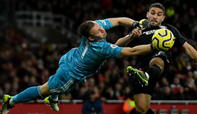 A goalie fights to stop a goal