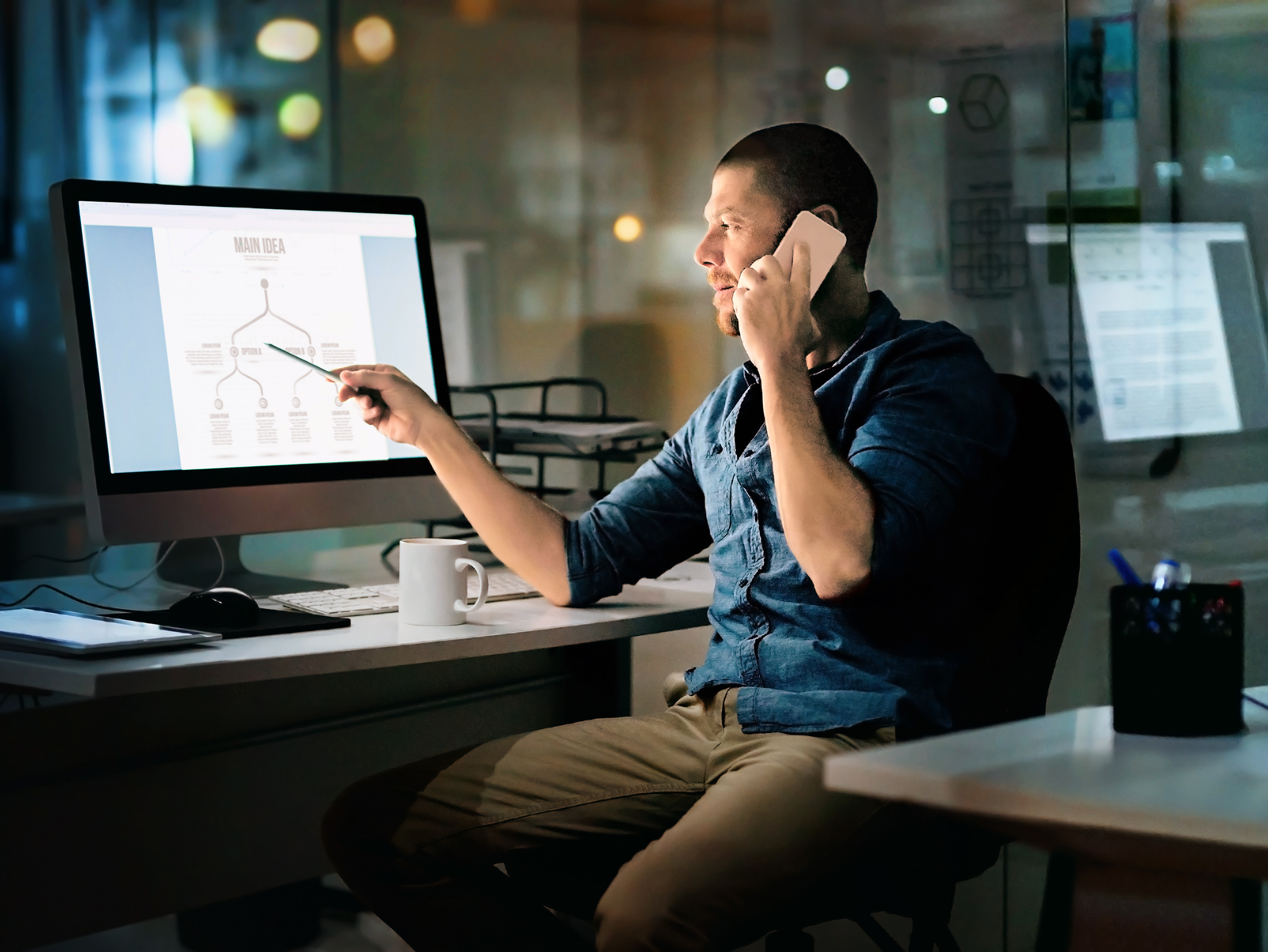 Man discussing a process diagram on his cellphone