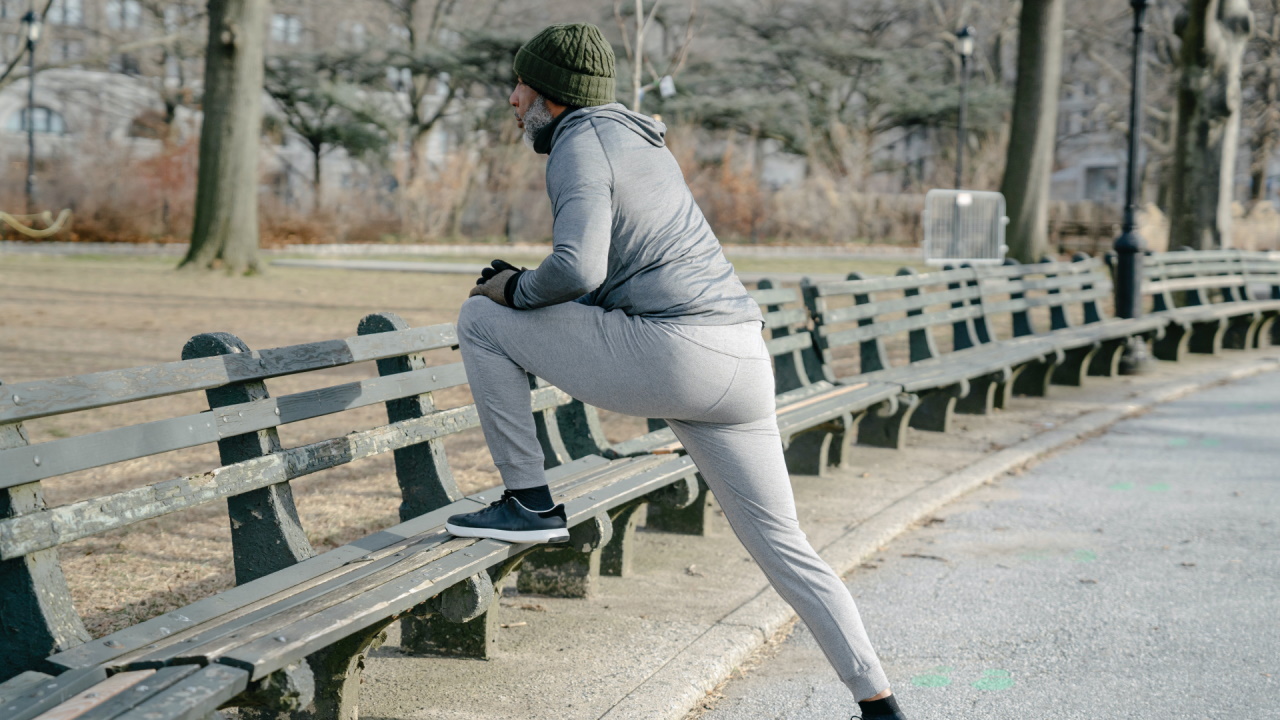 Person stretching on park bench