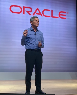 A person standing in front of a large screenDescription automatically generated with low confidence