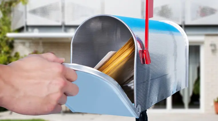 An image of a white hand opening a mailbox.