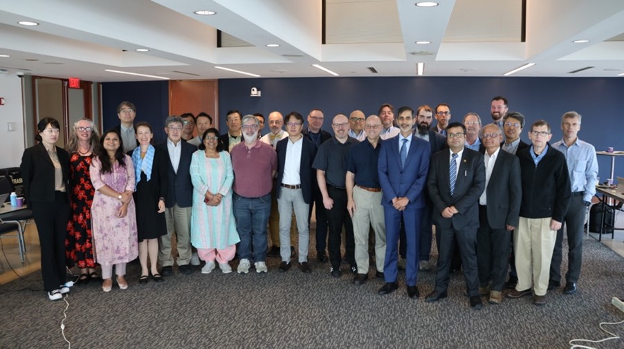A photo of members of the plenary meeting standing in a group
